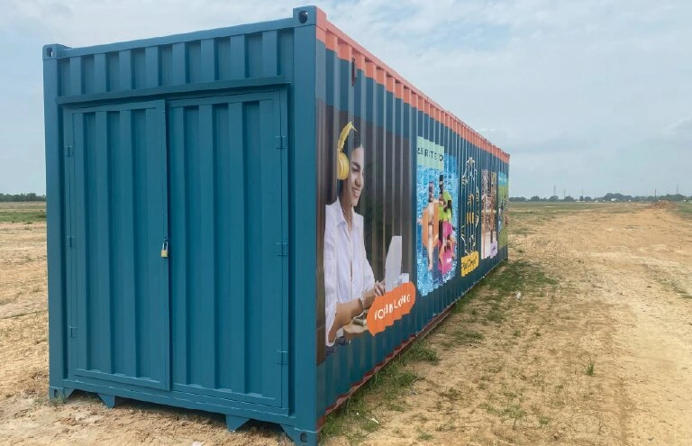 Close-up of vinyl wrap installation on shipping container corner