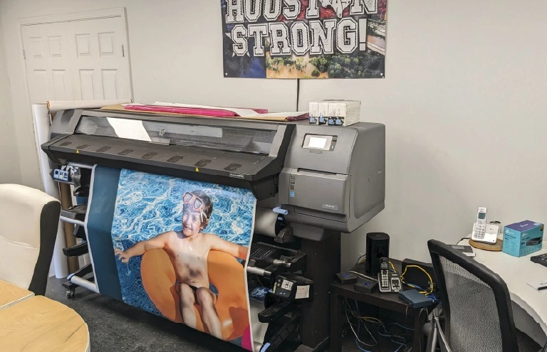 Printing of custom vinyl graphics for container used as mobile advertisement
